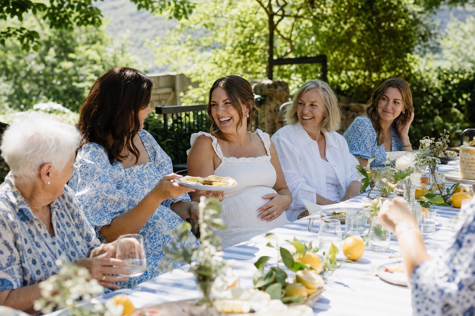 Emma and her family gathered around a long garden table for her Ciao Baby shower